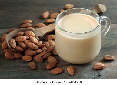 Almond Milk In A Glass Cup On A Wooden Table. Almonds And Milk