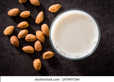 Almond Milk In Glass On Black Background. Top View