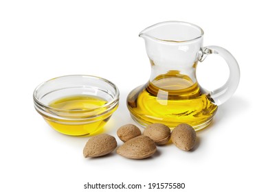 Almond oil and almonds on white background