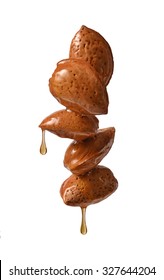 Almond oil drops concept on White background.