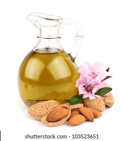 almond oil and almond nuts with flowers on white background