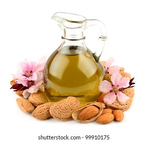 almond oil and almond nuts with flowers on white background
