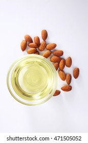 almond oil and almond seed isolated on white background