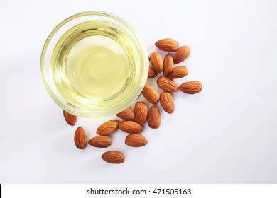 almond oil and almond seed isolated on white background