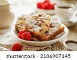 Almond raspberry bostock, traditional french sweet toast on a white plate, close up view. Delicious breakfast or dessert