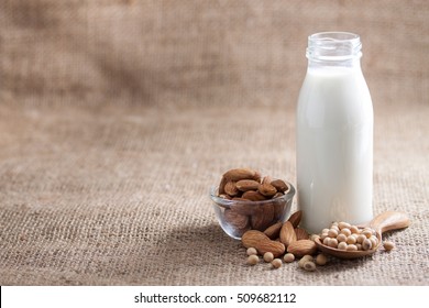 Almond And Soy Milk Or Soya Drink On Textile Texture And Background