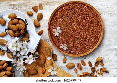 Almond Tart With Salted Caramel On A Wooden Table.