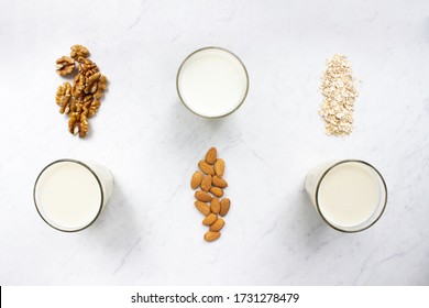 Almond, walnut, oat milk on marble background top view. Nut milk vegan lactose-free, dairy free milk drink. Health diet and nutrition. Stock photo. - Shutterstock ID 1731278479