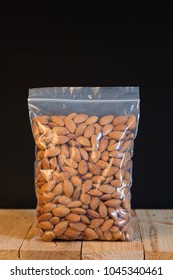 Almond In A Zipper Bag On Wood Table.