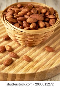  Almonds in a basket on a cutting board                              