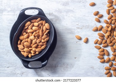 Almonds In Black Bowl On White Wooden Background, Almonds On White Wood Texture, Flatly Angle Photo Of Almonds 