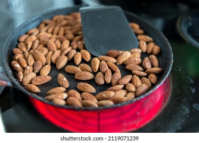 Almonds Are Fried In A Skillet On A Hot Stove. Top View.
