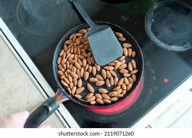 Almonds Are Fried In A Skillet On A Hot Stove. Top View.
