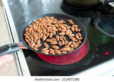 Almonds Are Fried In A Skillet On A Hot Stove. Top View.
