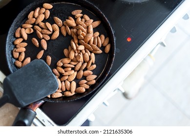 Almonds Are Fried In A Skillet On A Hot Stove. Top View.