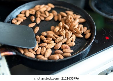 Almonds Are Fried In A Skillet On A Hot Stove. Top View.