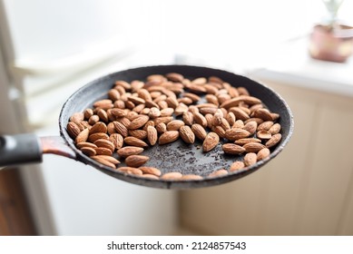 Almonds Are Fried In A Skillet On A Hot Stove. Top View.