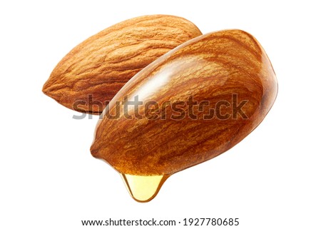 Almonds with oil drop isolated on white background 