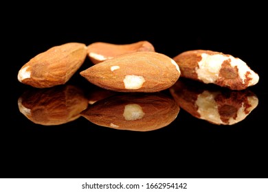 Almonds on a black background with reflection