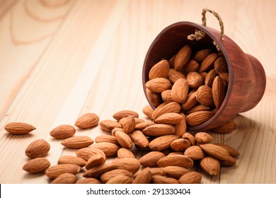 Almonds pour from wood Cup