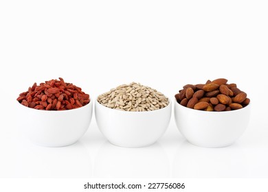 Almonds, Sunflower Seeds And Goji Berries On White Background