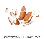 Almonds is torn to pieces close-up, isolated on white background