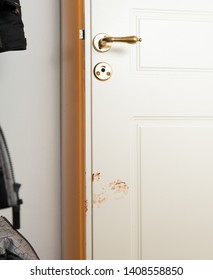 Almost Closed Bathroom Door With A Chocolate Hand Mark From A Child.