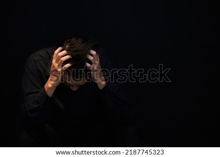 Almost crying desperate young man touching head and thinking about his mistake