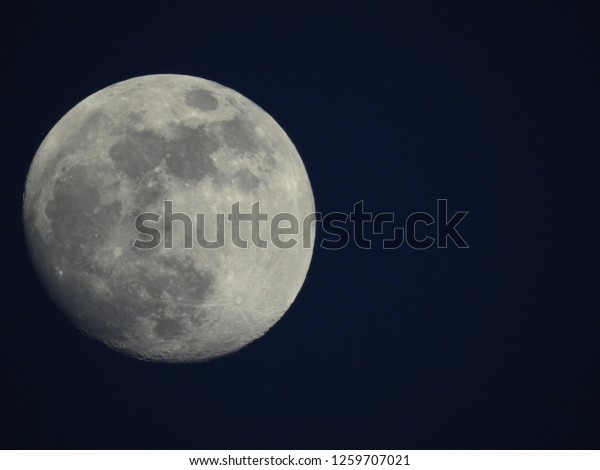 Almost full moon / The Moon is an astronomical\
body that orbits planet Earth and is Earth\'s only permanent natural\
satellite. It is the fifth-largest natural satellite in the Solar\
System