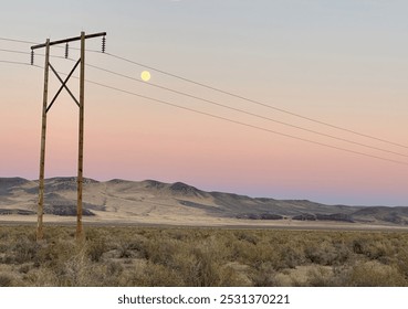 Almost full moon showing through an electric power line.  Pink sky
Yellow and brown hills. - Powered by Shutterstock