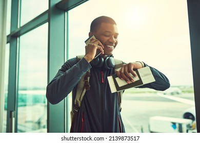 Almost Time For Me To Board. Shot Of A Young Man Checking The Time In An Airport.