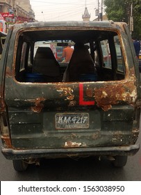 Almost Totaled Rusted Car With A Learning Sign On The Back - Karachi Pakistan . Nov 2019 