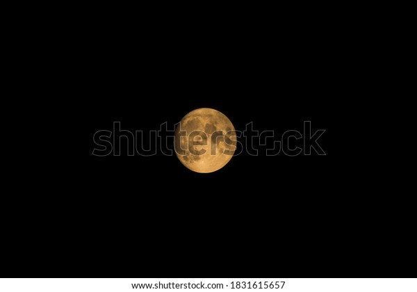 Almost-full, hazy, orange moon. Captured above\
Portland, Oregon in fall of\
2020.