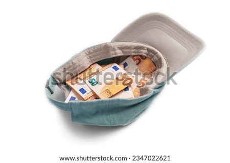 Alms baseball cap with euro banknotes. Money donation and poverty concept. Isolated on a white