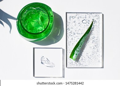 Aloe Vera Fresh Gel In A Plastic Bottle Flat Lay With  A Smear Of Transparent Gel And A Leaf. After Sun Cooling Skin Cosmetics Top View
 