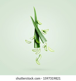 Aloe vera fresh leaf and pieces isolated on a green mint background. Healthy skincare ingredients for ad cosmetology mockup. Levitation concept for Ad.