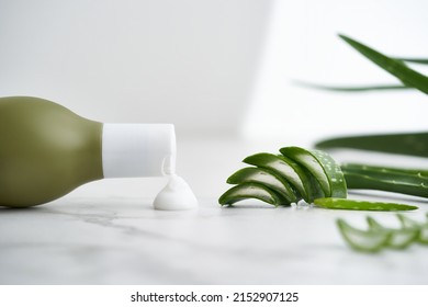 Aloe vera - leaves and cream on white background. Cosmetic bottle with aloe vera. Natural organic beauty product, hand skincare concept. Aloe vera leaf and cream container on white surface.  - Shutterstock ID 2152907125