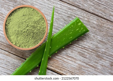 Aloe Vera Powder With Fresh Aloevera Leaf And Slice Isolated On Wooden Table Background. Top View. Flat Lay.