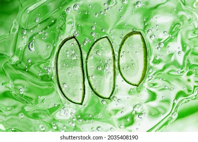 Aloe vera slice texture with gel on green background. Medicinal plant. Flat lay. Top view. Natural herbal medical plant, skincare, healthcare and beauty spa concept.