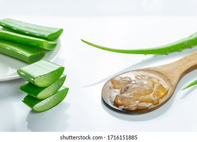 Aloe Vera sliced on wood spoon isolated on white background.