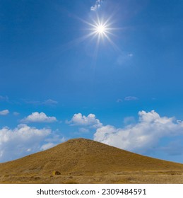 alone conical mount under a sparkle sun