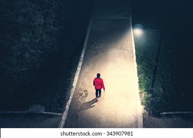 Alone Girl Walking In The Park In The Night