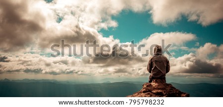 alone man sitting on the peak of mountain cloudy sky
lonely scene, waiting for hope, landscape panorama view, copy space