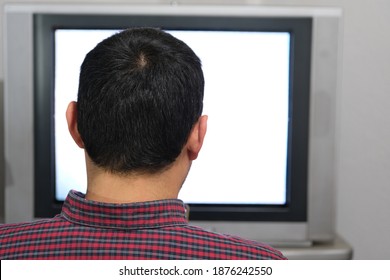 A Alone Man Is Watching Television. Photo Shows Behind Of The Man And His Head And Also In Old Style And Tube Television TV There Is Grainy Screen. Bursa Turkey 06.12.2020