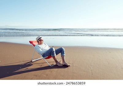 alone mature man lying on beach chair relaxing looking the horizon on the remote beach shore - Powered by Shutterstock