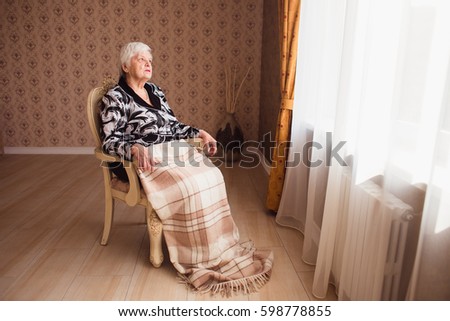 Similar – Senior woman in a wheelchair alone