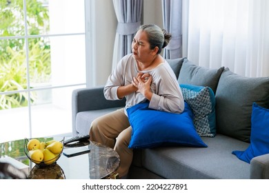 Alone Retired Asian Older Woman Having Pain At Chest. Heart Attack At Home.