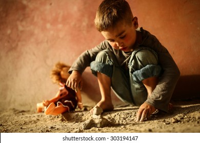 Alone Sad Child Playing On A Street