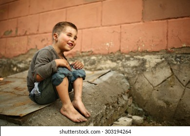 Alone Sad Child Playing On A Street