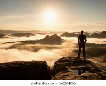 Alone tourist with red baseball cap sporty shorts stand on cliff edge and watching into deep valley bellow. Spring weather. Vintage Style Toned effect - Powered by Shutterstock